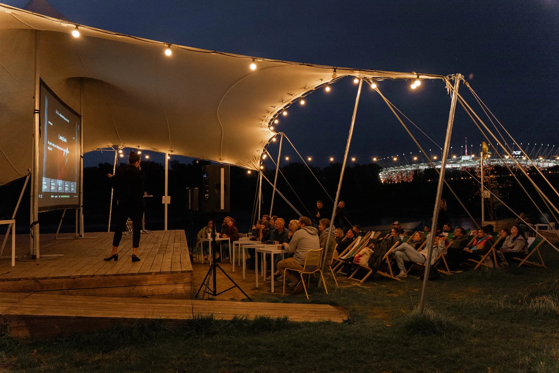 An evening Rewanż event at Plac Zabaw overlooking the National Stadium